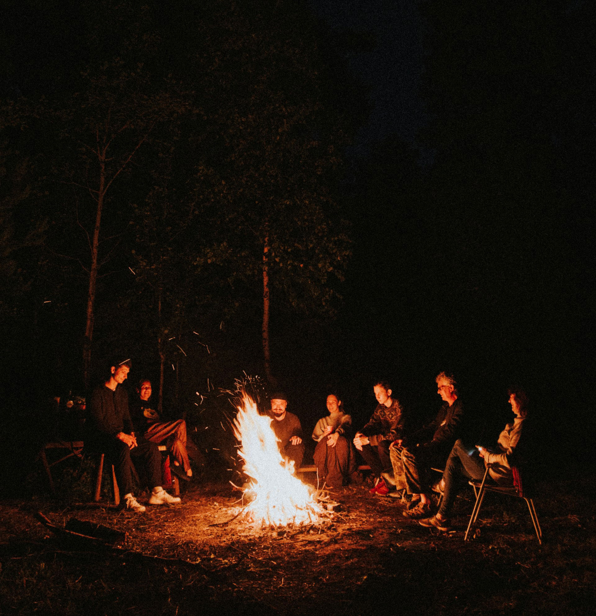 Family gathered around a campfire